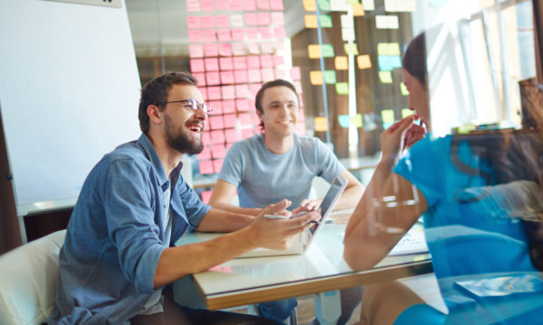 A group of people discussing how to sell their WordPress business.