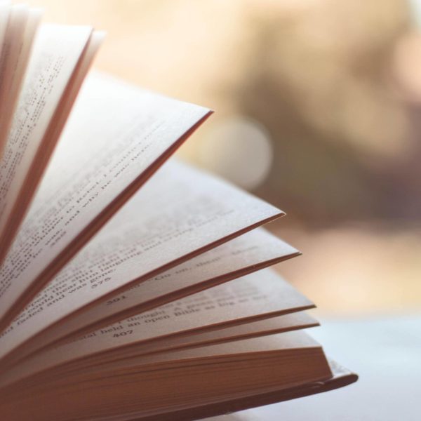 An open book invitingly positioned on a library table.