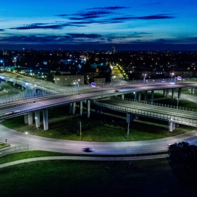 An illuminated cityscape showcasing transportation at night from an aerial vantage point.