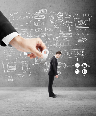 A businessman is showcasing a business card in front of a chalkboard, emphasizing the significance of Digital Marketing ROI.